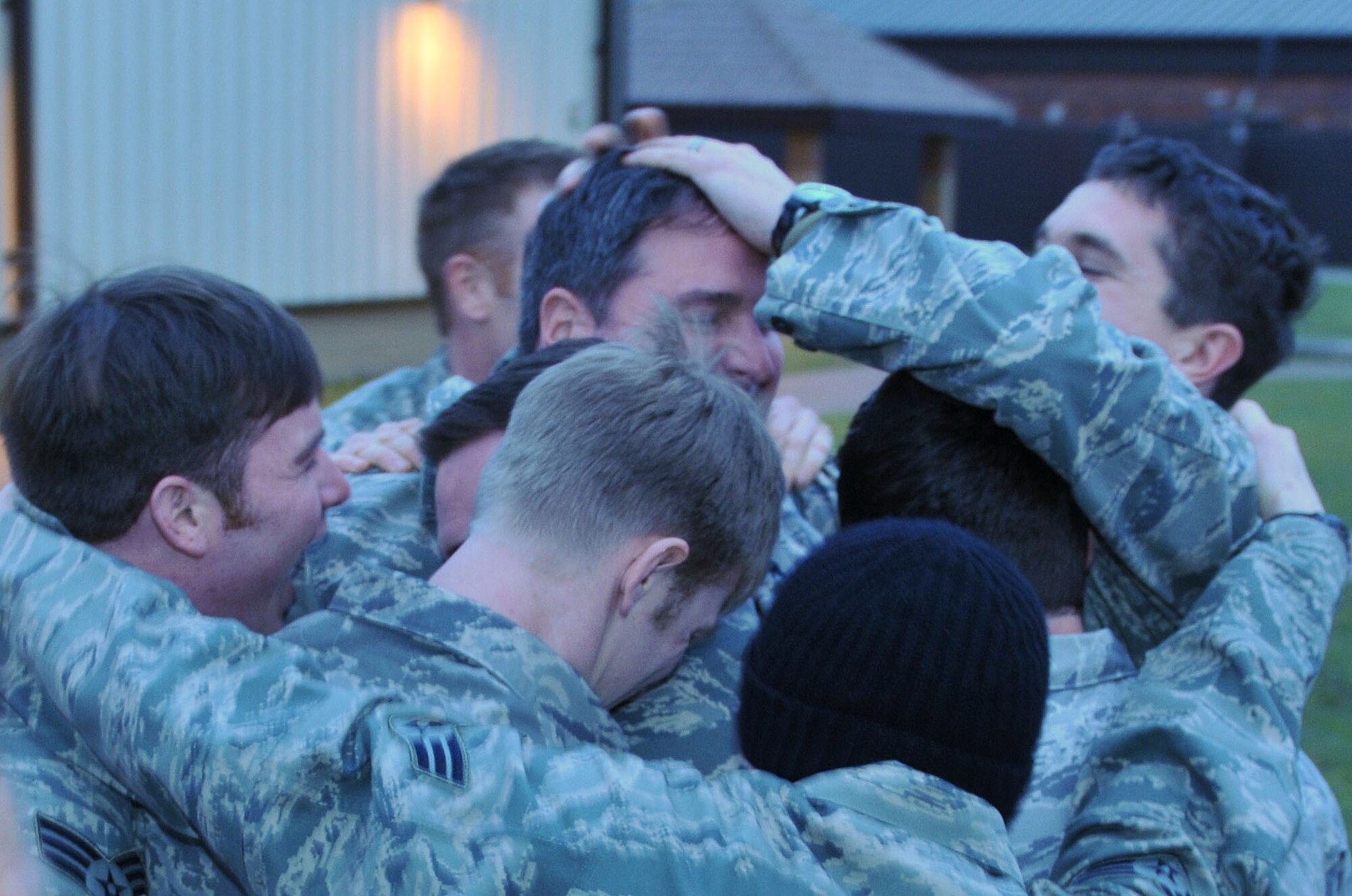 Pararescuemen from the 56th Rescue Squadron give Master Sgt. Todd Swartz, pararescue team superintendent, a quick goodbye before departing on their deployment from RAF Lakenheath, England Jan. 4. The pararescue team will perform combat search and rescue missions in Southwest Asia. (U.S. Air Force photo by Staff Sgt. Connor Estes)