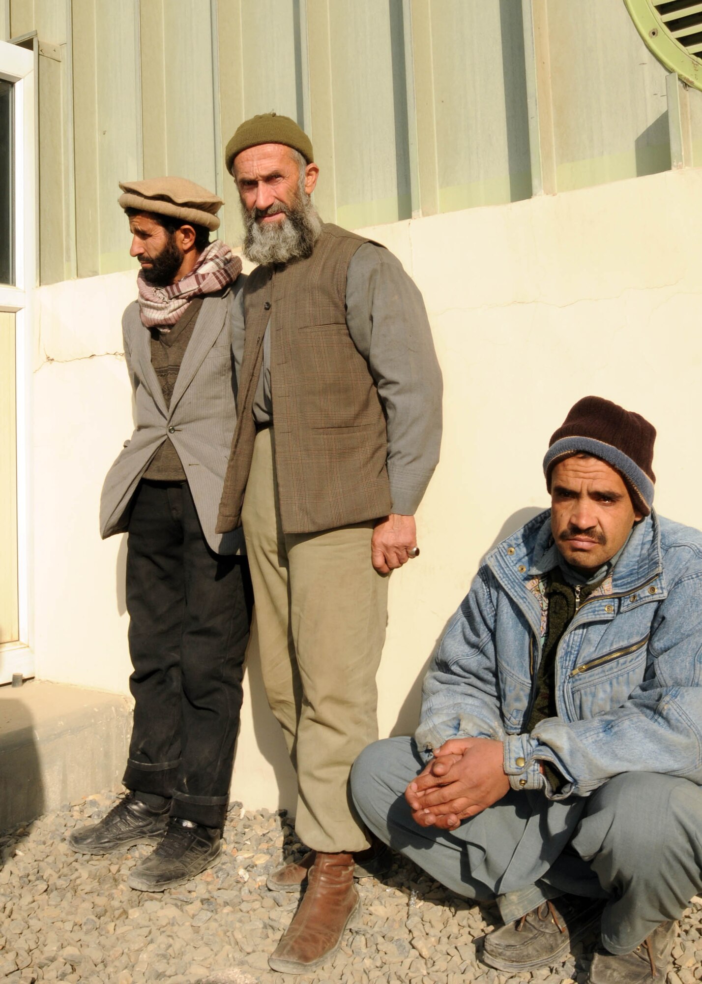 KABUL, Afghanistan - Afghan contractors wait for members of the Afghan Air Force, along with advisors from the 438th Air Expeditionary Wing, to distribute goods to them on the Afghan Air Force Base in Kabul, Afghanistan Jan. 5. (U.S. Navy photo by Mass Communications Specialist 3rd class Petty Officer Jared E. Walker/ RELEASED).
