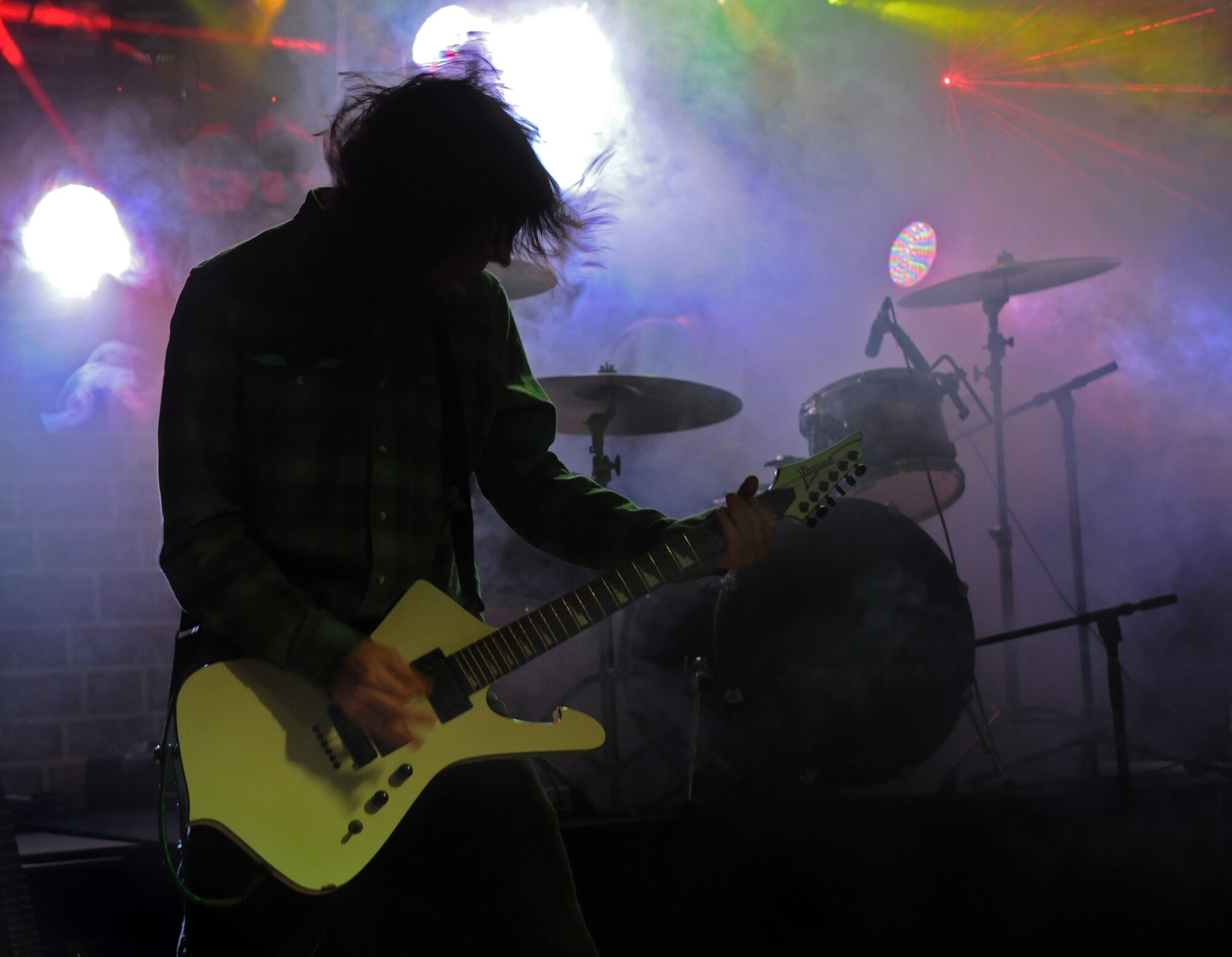 SPANGDAHLEM AIR BASE, Germany – Michael Thompson, guitarist and backup vocals for ACIDIC, plays on stage during a free concert at the Brick House Jan. 3. ACIDIC performed across Europe during their Armed Forces Entertainment Tour to entertain American servicemembers. (U.S. Air Force photo/Airman 1st Class Matthew B. Fredericks)
