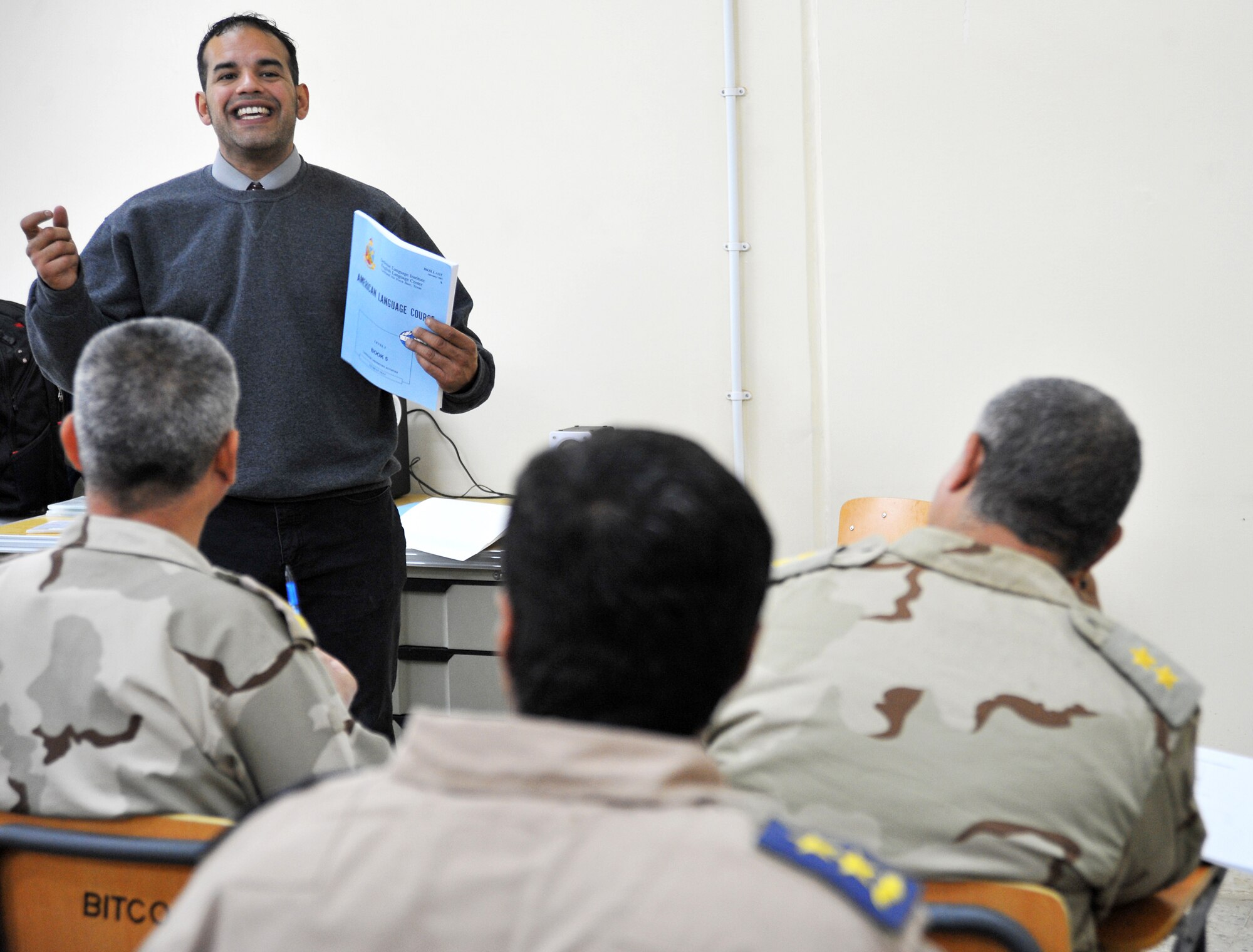 Joe Montalvo, an instructor at the Iraqi Air Force Training School, teaches a basic English language course to a class of Iraqi airmen Dec. 13, 2010, in Taji, Iraq. While air advisors work with the faculty to help them improve the way the overall program is run, it is the 19 U.S. contractors and lone DLI civilian who work face-to-face with the students. (U.S. Air Force photo/Senior Airman Andrew Lee)
