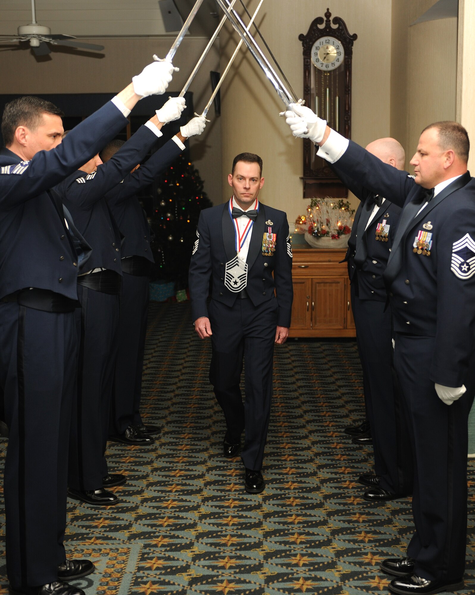 KUNSAN AIR BASE, Republic of Korea -- Senior Master Sgt. Gary Wakefield, 8th Aircraft Maintenance Squadron, walks by the saber team during a chief's recognition ceremony here Dec. 29. Chief Master Sgt. of the Air Force James Roy guest spoke at the ceremony, which was held to honor the Wolf Pack's newest chief master sergeant selects. (U.S. Air Force photo/Senior Airman Ciara Wymbs)