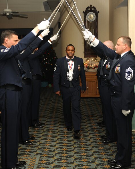 KUNSAN AIR BASE, Republic of Korea -- Senior Master Sgt. Michael Murdock, 8th Operations Support Squadron, walks by the saber team during a chief's recognition ceremony here Dec. 29. Chief Master Sgt. of the Air Force James Roy guest spoke at the ceremony, which was held to honor the Wolf Pack's newest chief master sergeant selects. (U.S. Air Force photo/Senior Airman Ciara Wymbs)