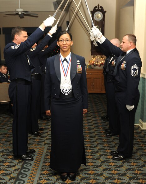 KUNSAN AIR BASE, Republic of Korea -- Senior Master Sgt. Christine Daniels, 8th Comptroller Squadron, walks by the saber team during a chief's recognition ceremony here Dec. 29. Chief Master Sgt. of the Air Force James Roy guest spoke at the ceremony, which was held to honor the Wolf Pack's newest chief master sergeant selects. (U.S. Air Force photo/Senior Airman Ciara Wymbs)