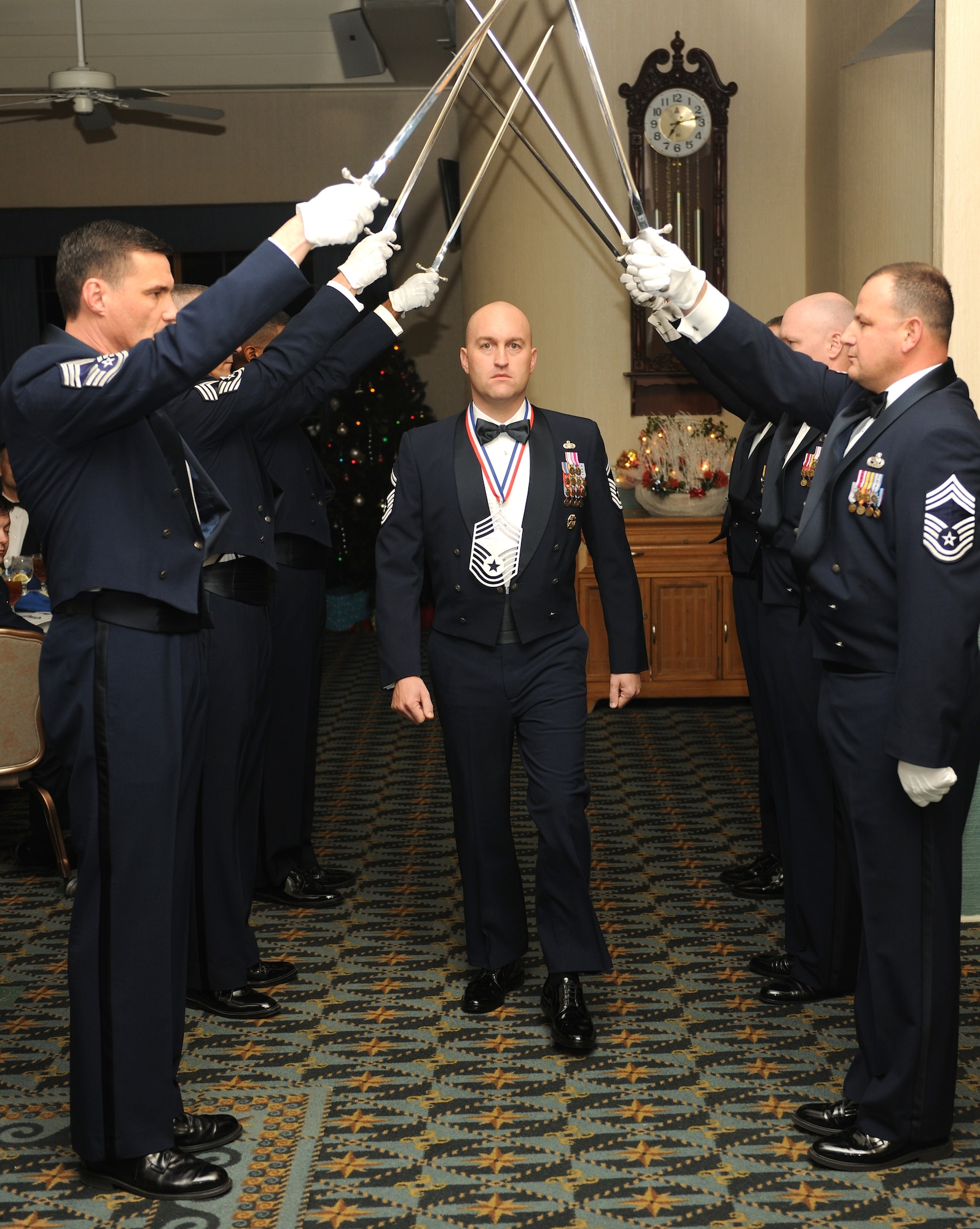 KUNSAN AIR BASE, Republic of Korea -- Senior Master Sgt. Troy Blackburn, 8th Security Forces Squadron, walks by the saber team during a chief's recognition ceremony here Dec. 29. Chief Master Sgt. of the Air Force James Roy guest spoke at the ceremony, which was held to honor the Wolf Pack's newest chief master sergeant selects. (U.S. Air Force photo/Senior Airman Ciara Wymbs)