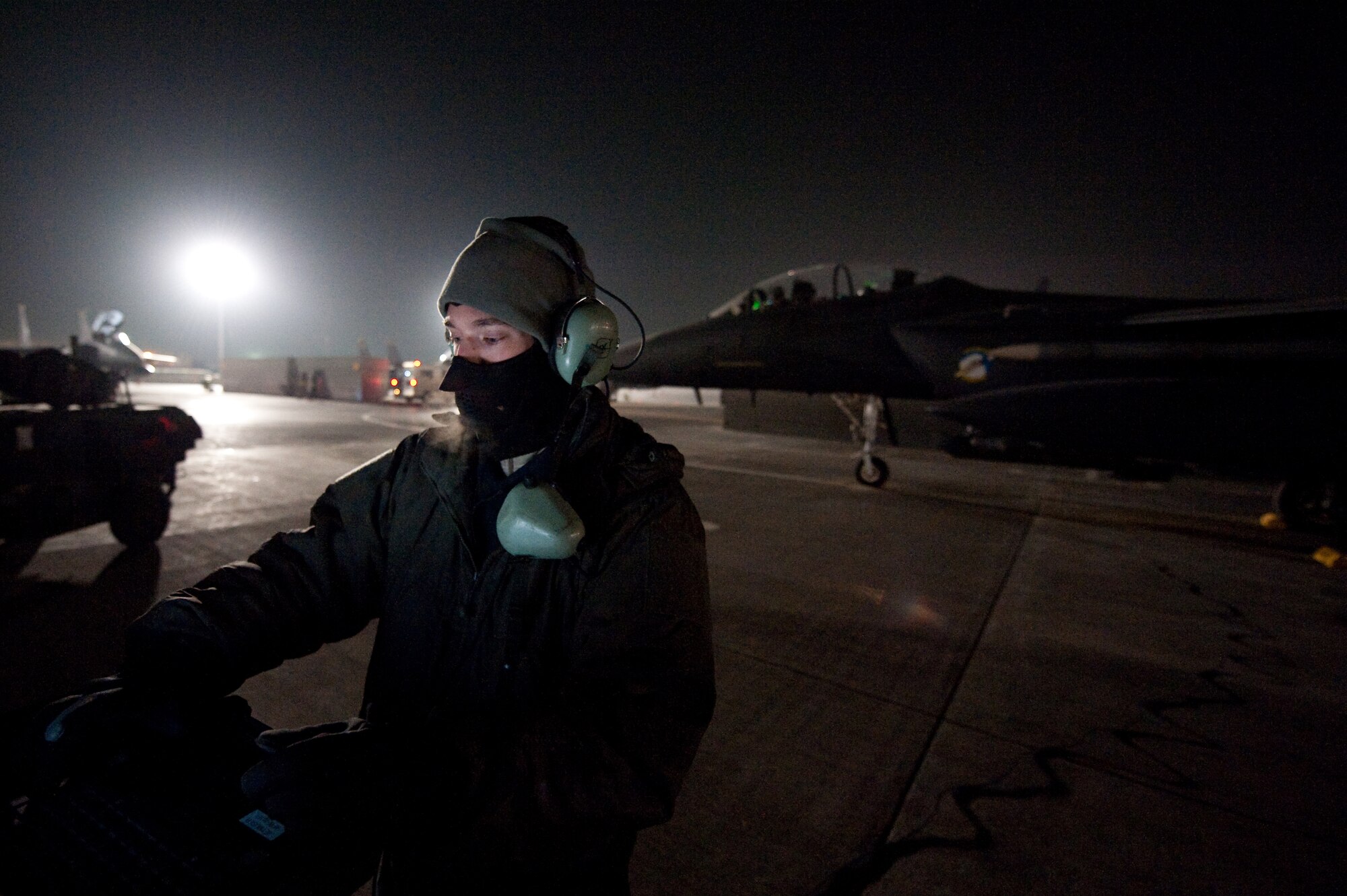 Airman 1st Class Isaac Hurd, a crew chief with the 455th Expeditionary Aircraft Maintenance Squadron, prepares a F-15E to take off from Bagram Airfield, Afghanistan, Jan. 4, 2011. The 455th EAMXS maintains F-15E's here at Bagram is deployed from Seymour Johnson Air Force Base, N.C. (U.S. Air Force by Staff Sgt. Robert Barney)