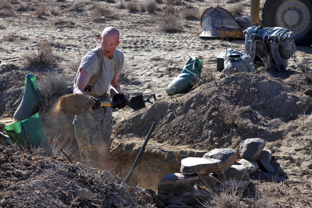 U.S. Army Sgt. Maj. Travis Votaw digs a ranger grave during Operation Koranai Permakhtag at Bora Jengi checkpoint, Zabul province, Afghanistan, Dec. 21, 2010. Votaw is assigned to the U.S. Security Forces Advisory Team, 3rd Zone Afghan Border Police.