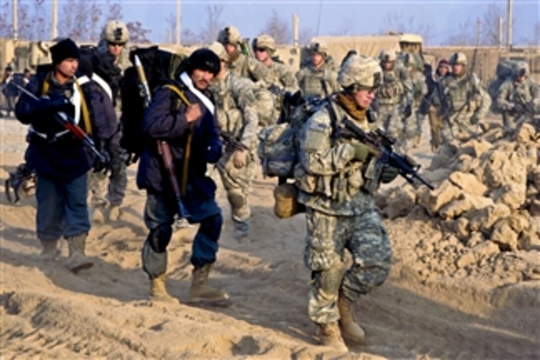 U.S. Army soldiers and Afghan police move out on a foot patrol in the Isa Khan region of Afghanistan's northern Kunduz province on Dec. 28, 2010.  The soldiers are assigned to the 10th Mountain Division’s Company A, 1st Battalion, 87th Infantry Regiment, 1st Brigade Combat Team.  