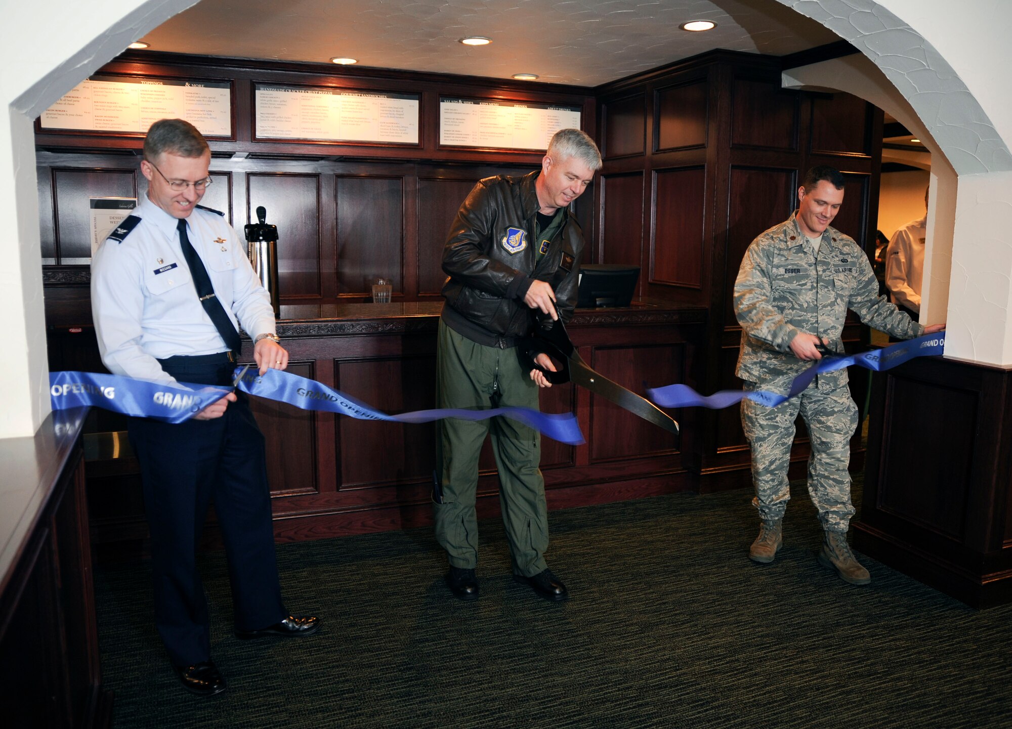 U.S. Air Force Col. Van Wimmer, center, 35th Vice Wing Commander, Col. David Wiegand, left, 35th Mission Support Group Commander and Maj. Thomas Esser, 35th Force Support Squadron Commander cut a ribbon during the opening ceremony of the newly renovated Lakeview Grille at Misawa Air Base, Japan, Jan. 5, 2011. The renovation started in May 2010 and finished January  2011. The project was a joint effort between Chris Anest, a local carpenter, and Airmen from the 35th Civil Engineer and 35th Logistics Readiness Squadrons.   (U.S. Air Force photo by Tech. Sgt. Russell McBride/Released)