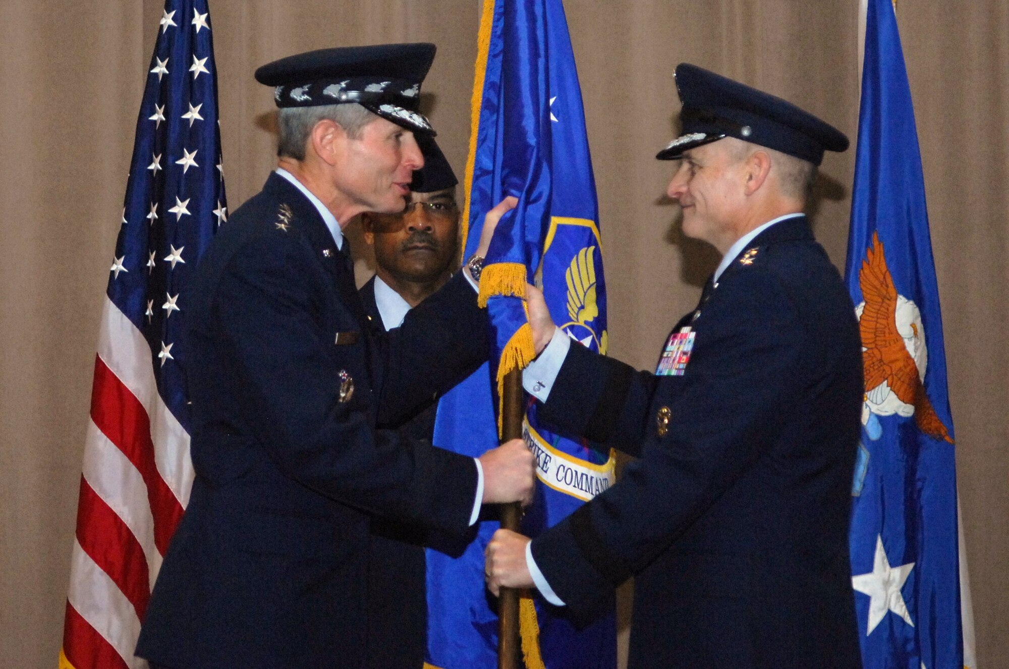 Air Force Chief of Staff Gen. Norton Schwartz passes the Air Force Global Strike Command guidon to Lt. Gen. James Kowalski Jan. 6, 2011, at Barksdale Air Force Base, La., as General Kowalski  assumed command, becoming responsible for organizing, training and equipping all U.S. ICBM and nuclear-capable bomber forces.  Command Chief Master Sgt. Jack Johnson serves in his role as guidon bearer.  (U.S. Air Force photo/Master Sgt. Corey Clements)