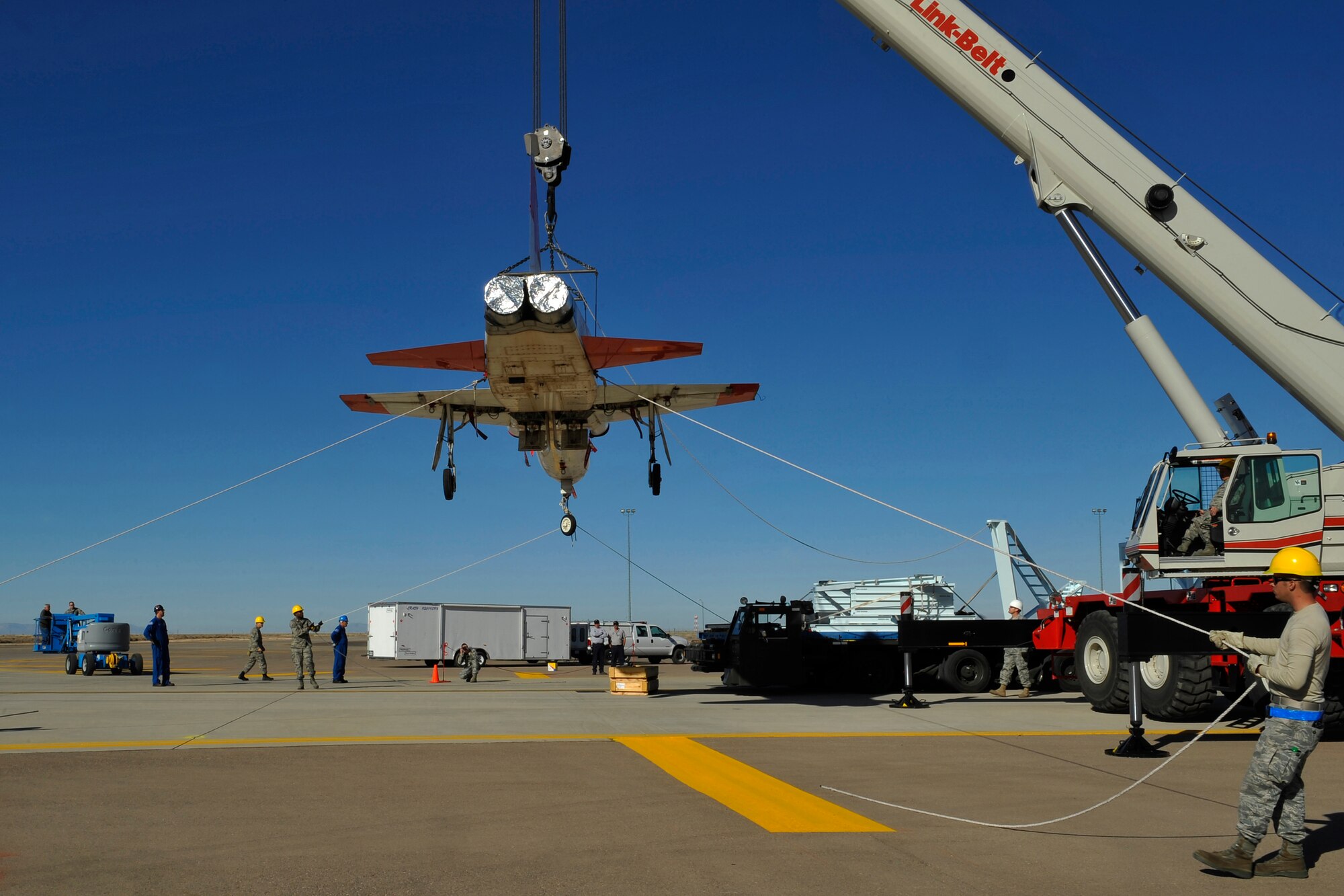 HOLLOMAN AIR FORCE BASE, N.M. -- Members of the 49th Aircraft Maintenance Squadron hold tether lines during the unloading of two T-38 Talons Dec. 14, 2010.The U.S. aircraft were used by the Republic of South Korea for training until 2009 and will now be regenerated and used as fifth generation fighter support. M1 Support Services at Holloman will regenerate theT-38s before they are sent to Joint Base Langley-Eustis, Va. (U.S. Air Force photo by Senior Airman Veronica Stamps/ Released)