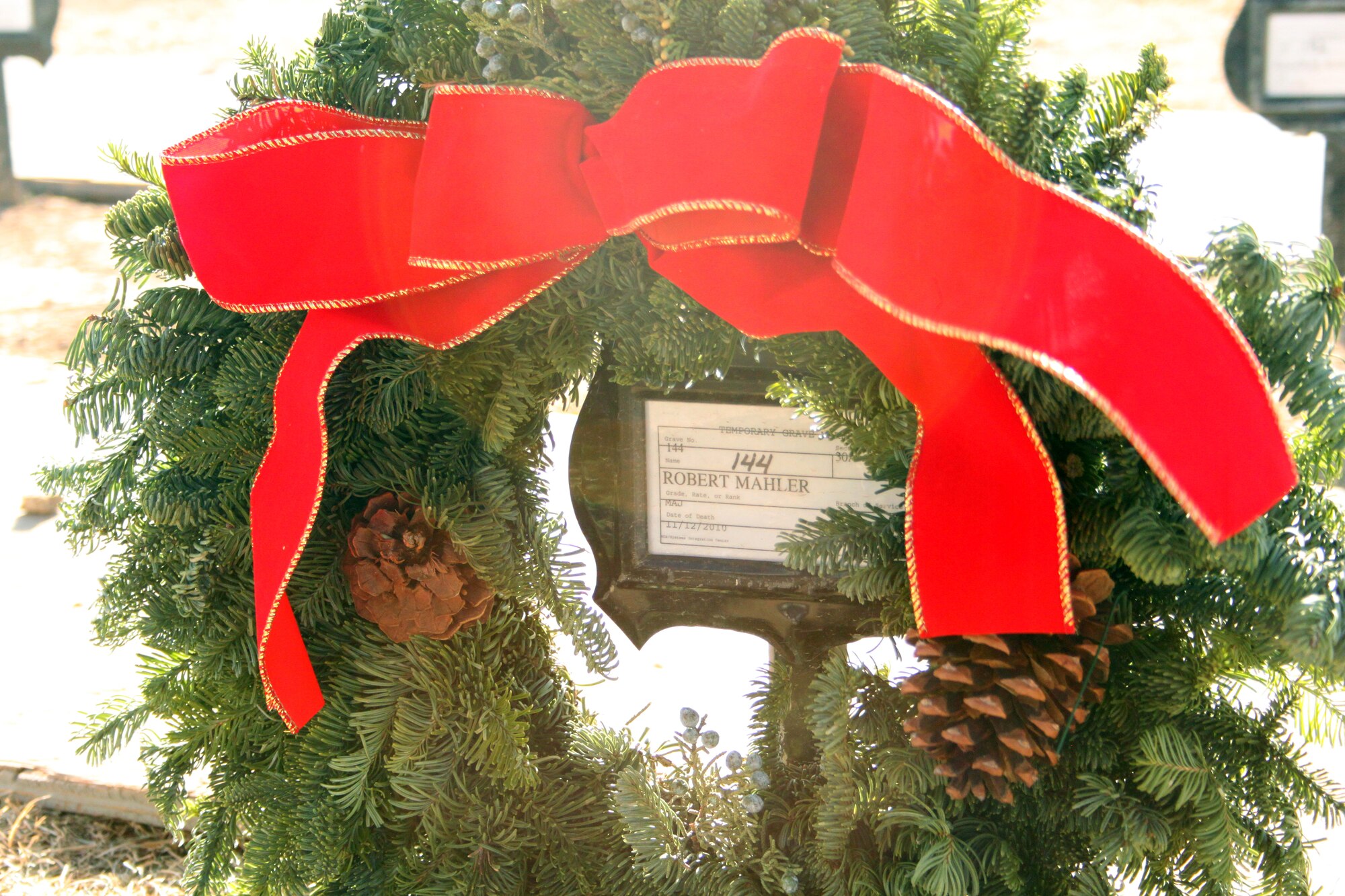 310th Space Wing members Lt. Col. Hung Tang, Chief Master Sgt. Robert Cherry and 302nd Airlift Wing Chief Master Sgt. Suzette Cherry laid a wreath at the unfinished gravesite of retired Maj. Robert Mahler, who had passed away at the age of 42 shortly after retiring from service with the 8th Space Warning Squadron at Buckley Air Force Base, Colo. 
