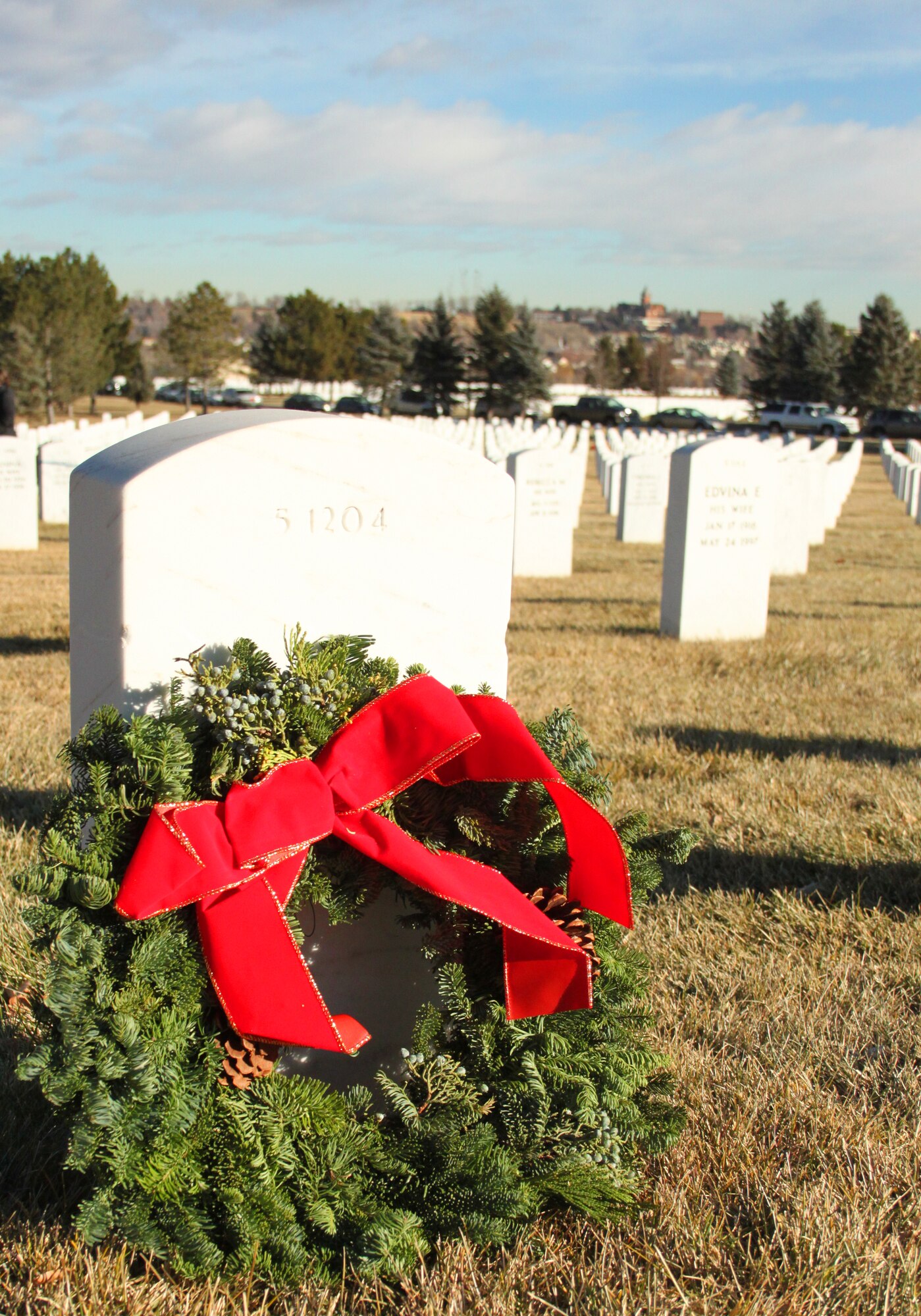 Members of the 310th Space Wing paid their respects to fallen veterens at a Wreaths Across America ceremony at Fort Logan National Cemetery near Denver on Dec. 11. Following the ceremony, over 500 wreaths were placed on graves around the cemetery.
