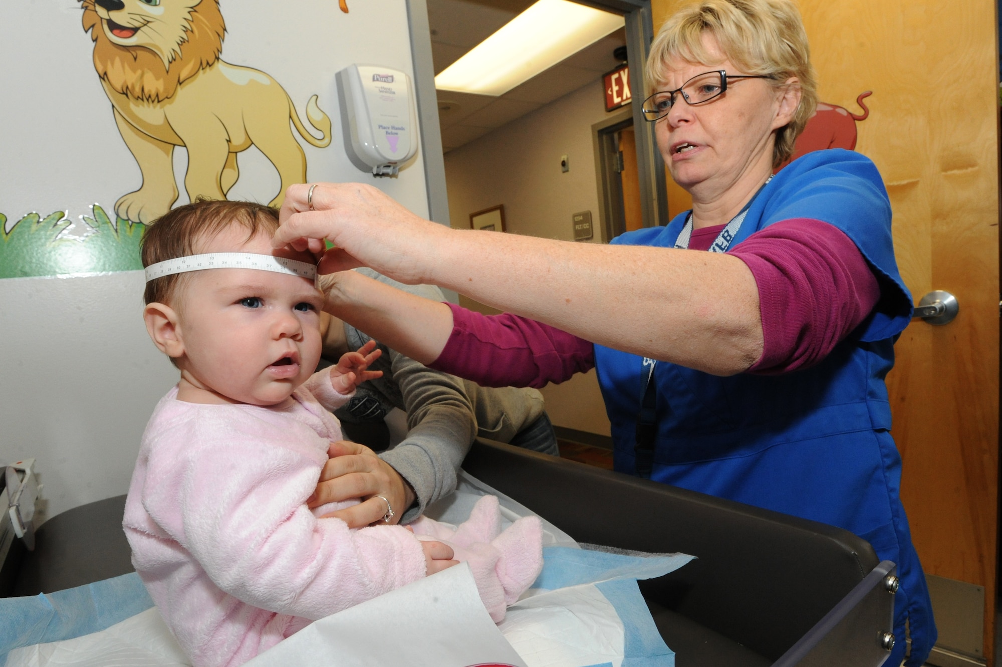 WHITEMAN AIR FORCE BASE, Mo. - Isabella D’Amico, four-month-old and daughter of Marie and Tech. Sgt. William D’Amico, 509th Aircraft Maintenance Squadron gets her head measured by Julie Durham, 509th Medical Operation Squadron licensed practical nurse to ensure proper growth Jan. 6. The pediatric clinic closely monitors baby growth to ensure the child is healthy. (U.S. Air Force photo by Senior Airman Carlin Leslie)