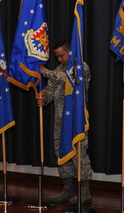 Chief Master Sgt. Jeffrey Cui, U.S. Air Force Expeditionary Center command chief master sergeant, replaces the 18th Air Force flag with the U.S. Air Force Expeditionary Center flag during a re-alignment ceremony at Joint Base McGuire-Dix-Lakehurst, N.J. Jan. 6. The Expeditionary Center assumed command of five former 18th Air Force units as part of re-structuring within Air Mobility Command. (U.S. Air Force photo by Tech. Sgt. Zachary Wilson/Released) 