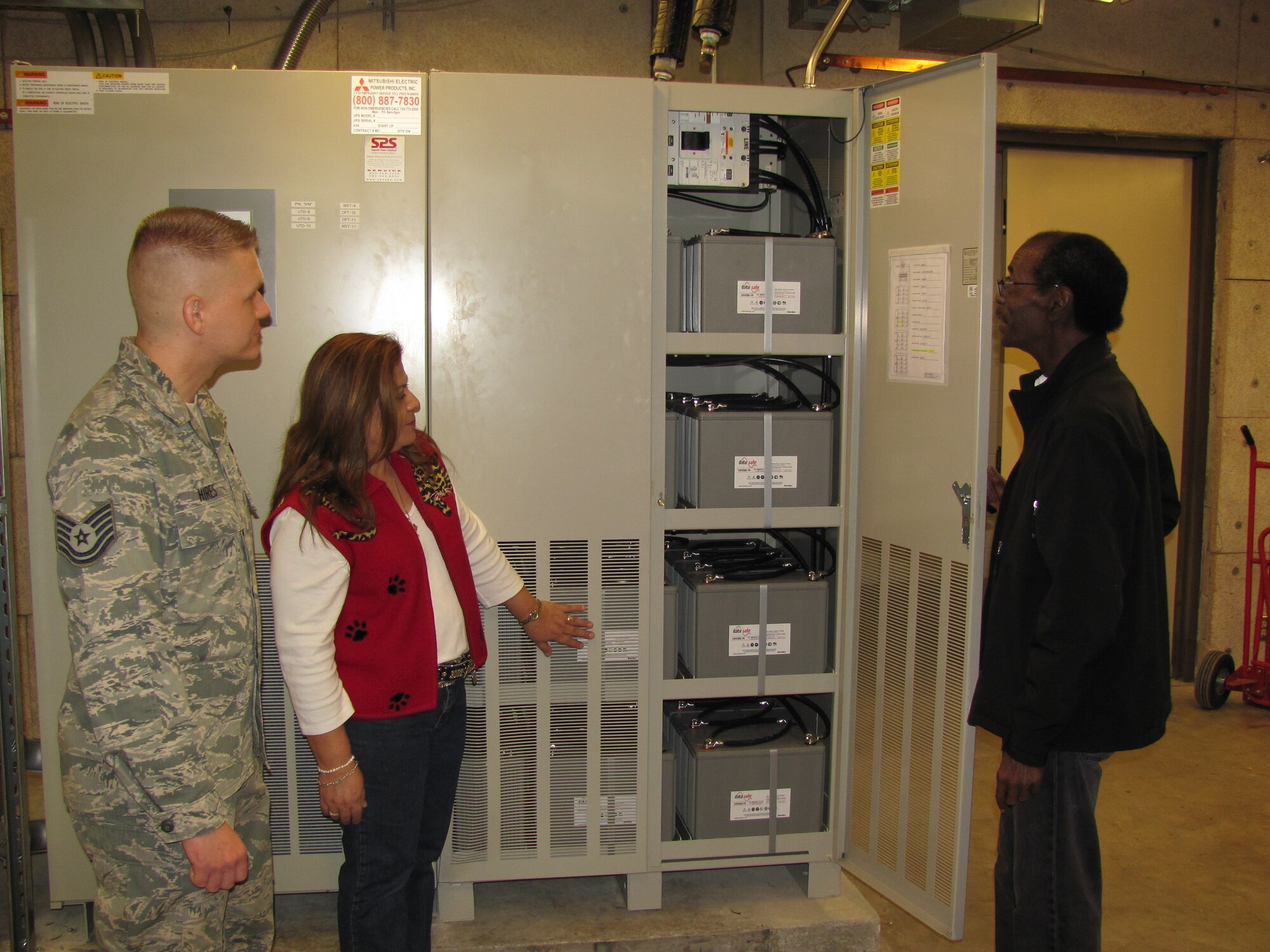 LAUGHLIN AIR FORCE BASE, TEXAS - John Freeman, 47th Operations Group, shows off Laughlin’s new Uninterruptable Power Supply system to Sylvia Garza and Tech Sgt. Shawn Hires, both of the 47th Contracting Squadron. All three were key in Laughlin’s purchase of the new system that powers the flight simulators here if the main power source goes down. (U.S. Air Force Photo by 2nd Lt. Travis Antoniono)