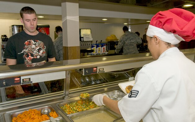 Senior Airman Marie Brown, 2nd Force Support Squadron food operations team member, serves lunch to a patron at the Red River Dining Facility on Barksdale Air Force Base, La. The Red River Dining Facility has recently changed their menu to include even more healthy food options for Airmen. (U.S. Air Force photo by Senior Airman Chad Warren)(RELEASED)