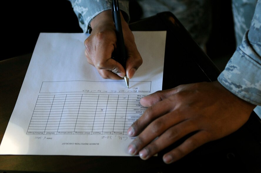 Airman Jose Gil, 2nd Civil Engineer Squadron firefighter, signs for his bunker inspection Jan. 6 at Barksdale Air Force Base, La. Firefighters perform bunker inspections at least once per month to ensure their equipment is in good working order and that it is all there. They inspect their equipment looking for tears, holes or anything that may hinder their safety. (U.S. Air Force photo/Staff Sgt. John Gordinier)
