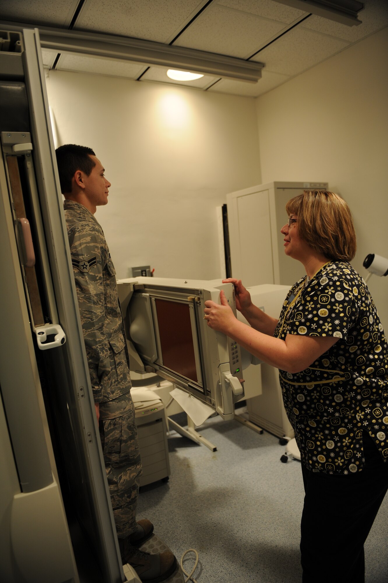 Roberta Gain, 375th Medical Support Squadron Diagnostic Imaging Flight X-ray technologist, prepares a patient for a fluoroscopy X-ray Jan. 4, 2011, at the Scott Family Clinic. A fluoroscopy X-ray is similar to taking a video X-ray, rather than a regular X-ray. (U.S Air Force photo/Staff Sgt. Teresa M. Jennings)
