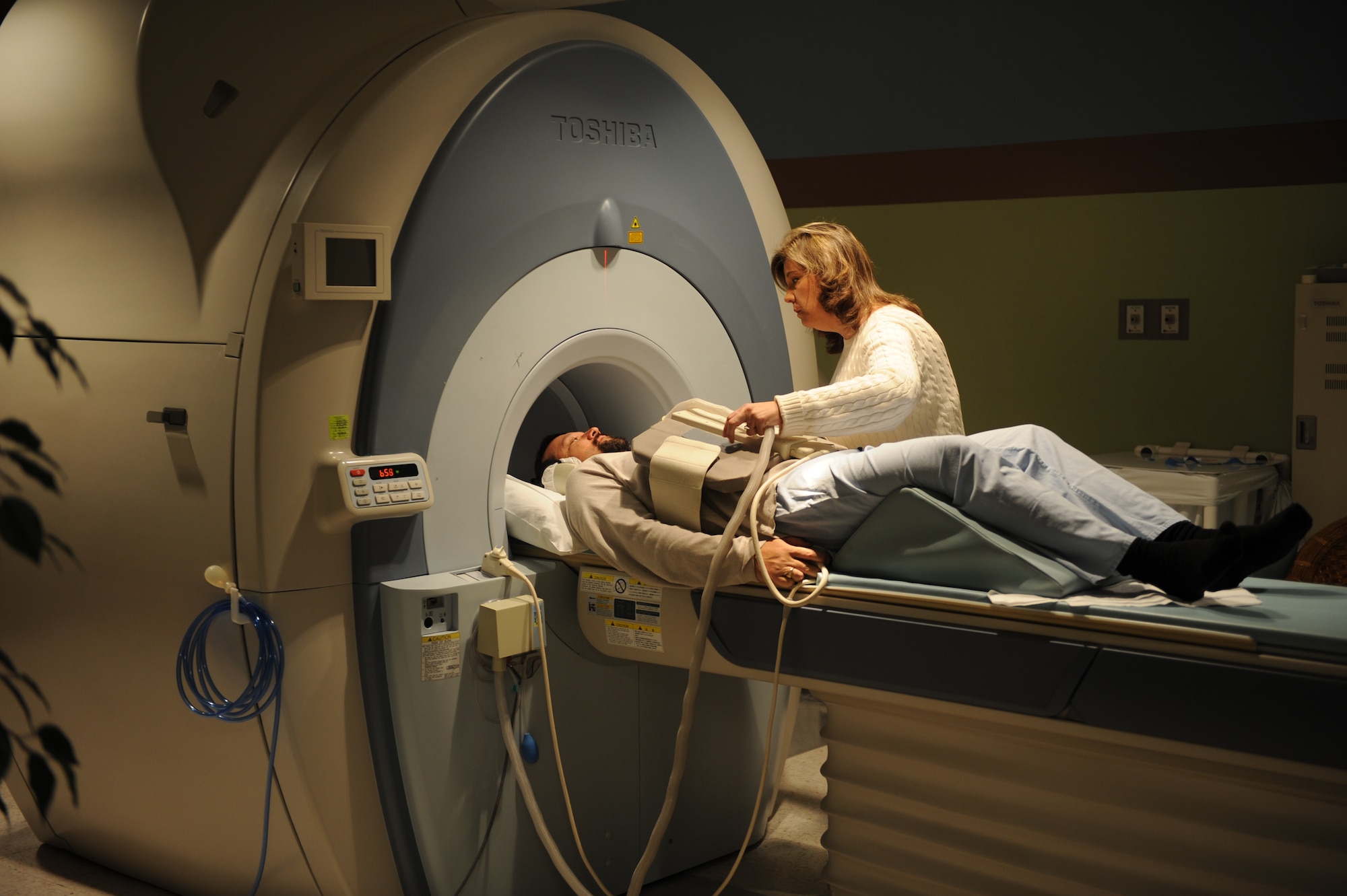 Susan Priebe, 375th Medical Support Squadron Diagnostic Imaging Flight MRI technologist, prepares a patient for an MRI Jan. 4, 2011, at the Scott Family Clinic. The 375th Medical Support Squadron Diagnostic Imaging Flight has some of the best and up-to-date technology in the Clinic. (U.S Air Force photo/Staff Sgt. Teresa M. Jennings)