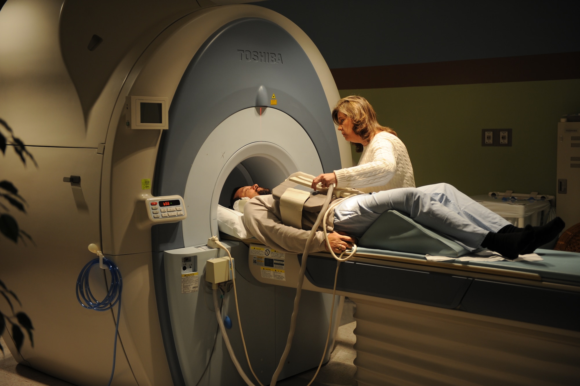 Susan Priebe, 375th Medical Support Squadron Diagnostic Imaging Flight MRI technologist, prepares a patient for an MRI Jan. 4, 2011, at the Scott Family Clinic. The 375th Medical Support Squadron Diagnostic Imaging Flight has some of the best and up-to-date technology in the Clinic. (U.S Air Force photo/Staff Sgt. Teresa M. Jennings)