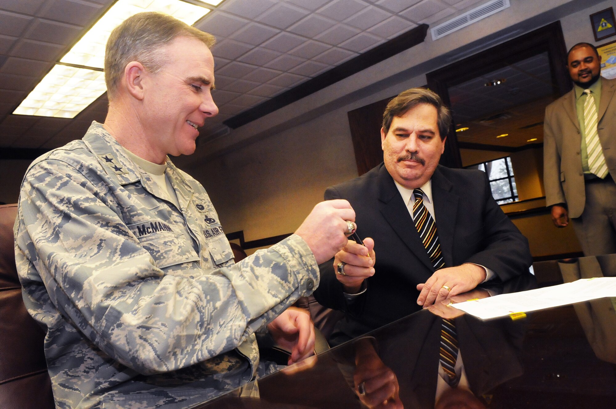 Maj Gen Robert McMahon, Warner Robins Air Logistics Center commander, presents the signing pen to Tom Scott, American Federation of Government Employees, Local 987 president, at the Labor-Management Partnership Agreement ceremony Jan. 5. U. S. Air Force photo by Sue Sapp