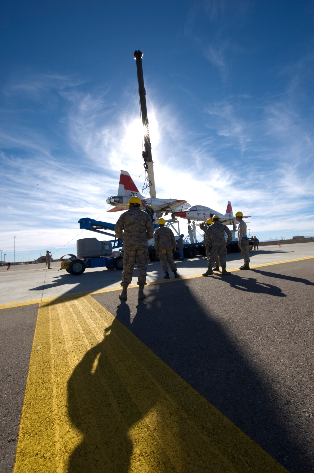 HOLLOMAN AIR FORCE BASE, N.M. -- Members of the 49th Aircraft Maintenance Squadron prepare to assist in the lifting of a T-38 Talon Dec. 14, 2010. The aircraft, flown to Holloman by the NASA's Super Guppy aircraft, are the first two of 15 to be shipped here after being used by the Republic of South Korea for training. Holloman's T-38 Consolidated Aircraft Maintenance program will be responsible for regenerating all of the aircraft before they are shipped to their designated operating location where they will be used for training. (U.S. Air Force photo by Airman 1st Class Joshua Turner/Released)