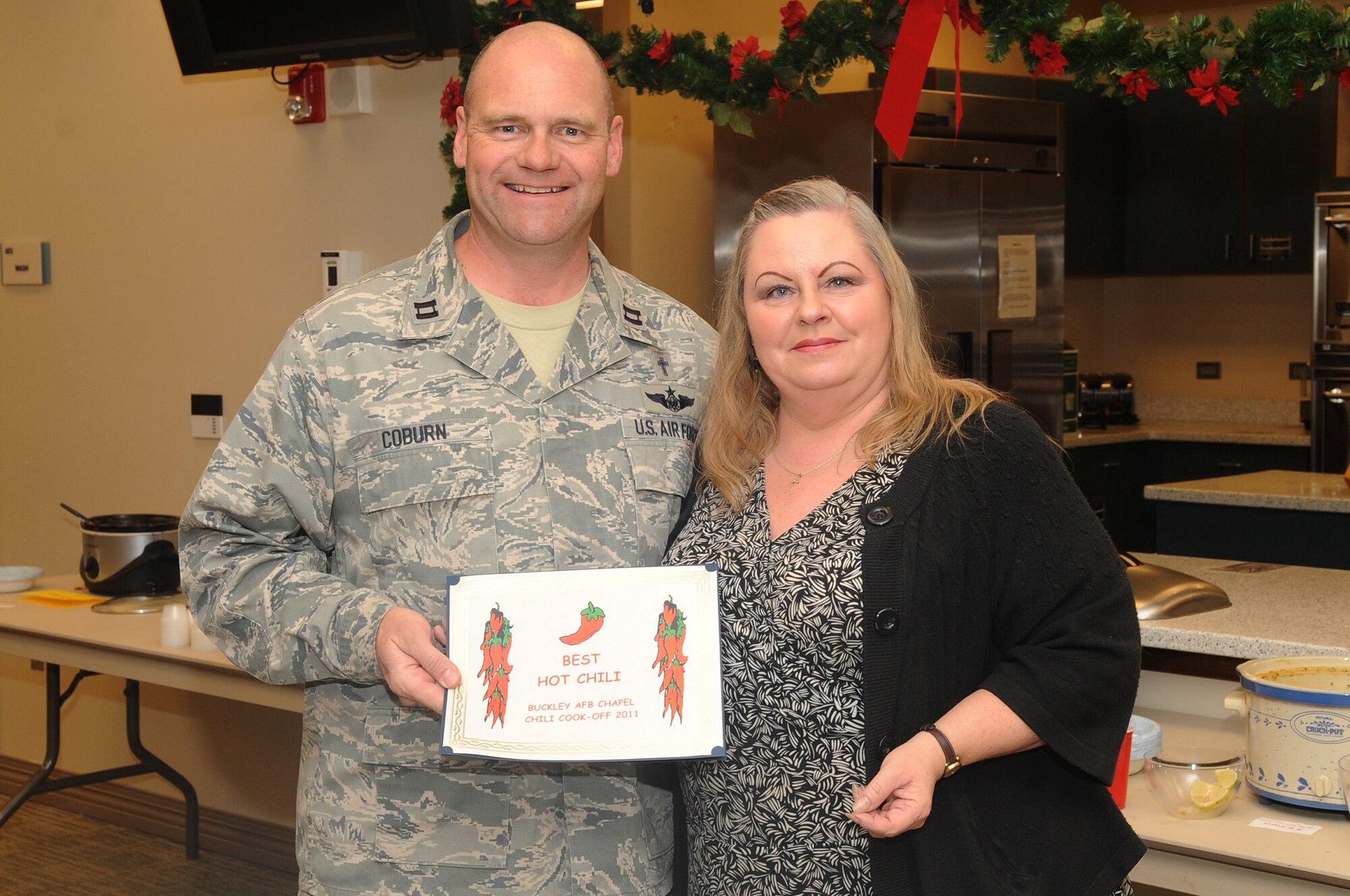 BUCKLEY AIR FORCE BASE, Colo.-- Debbie Cruz wins one of five awards during the annual chili cook-off at the chapel, Jan. 5, 2011. Mrs. Cruz won in the Hottest Chili category of the competition. (U.S. Air Force photo by Airman Manisha Vasquez)