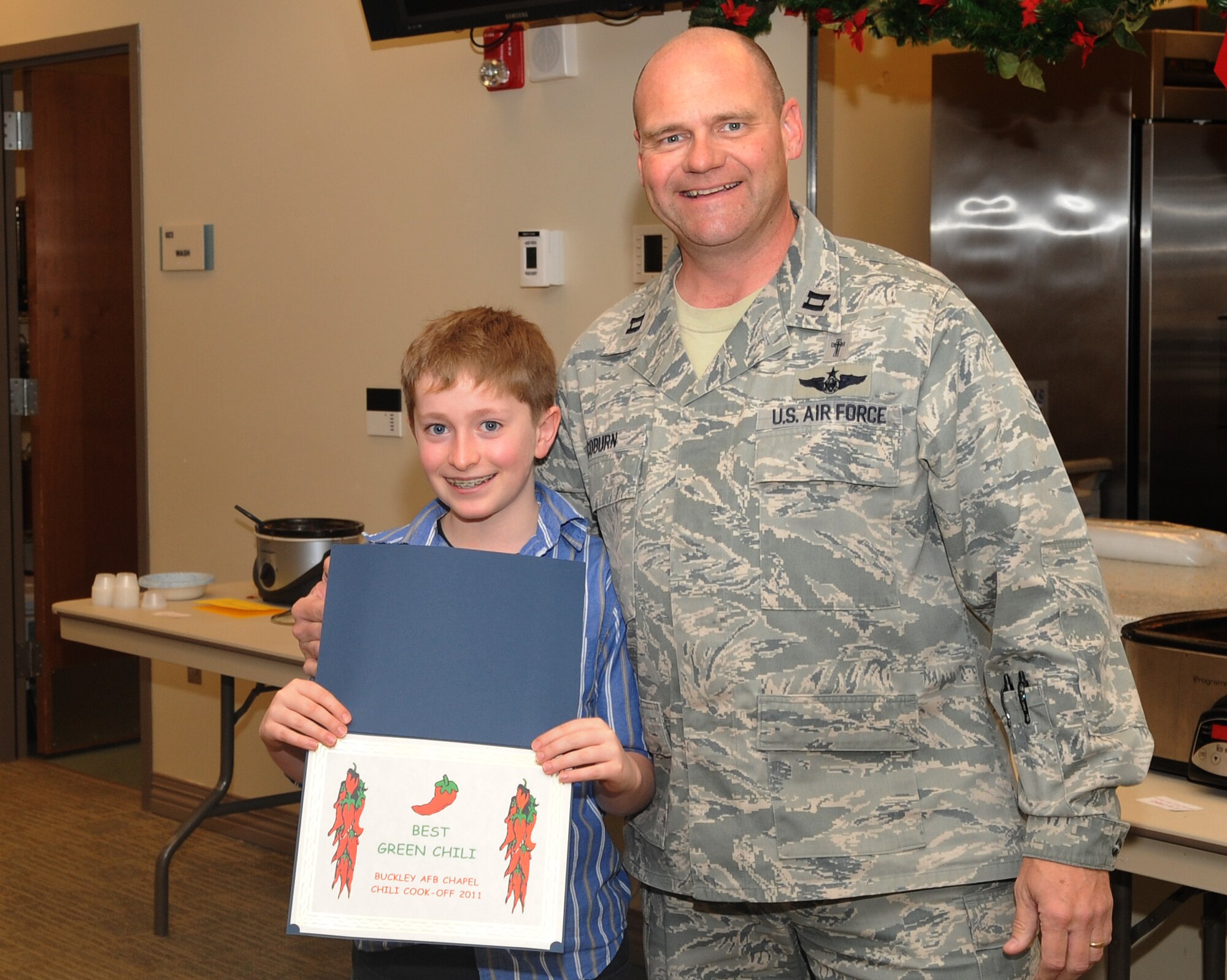 BUCKLEY AIR FORCE BASE, Colo.-- David Zulli wins an award during the eighth annual chili cook-off at the chapel, Jan. 5, 2011. Mr. Zulli won in the Best Green Chili category of the competition. (U.S. Air Force photo by Airman Manisha Vasquez)