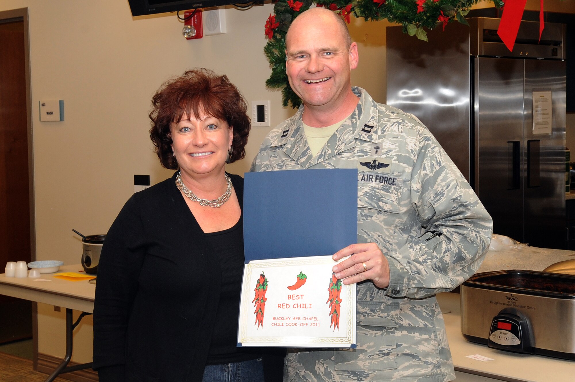 BUCKLEY AIR FORCE BASE, Colo.-- Cindy Zulli wins an award during the annual chili cook-off at the chapel, Jan. 5, 2011. Mrs. Zulli won in the Best Red Chili category of the competition. (U.S. Air Force photo by Airman Manisha Vasquez) 
