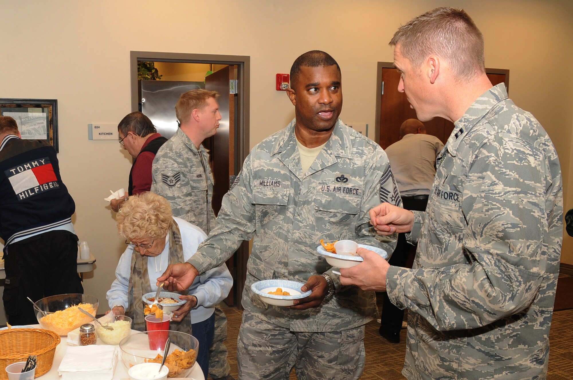 BUCKLEY AIR FORCE BASE, Colo.-- Team Buckley members gather at the eighth annual Chili Cook-off at the base chapel, Jan. 5, 2011. Members sampled great chili, mingled with one another and got to vote on their favorite chili at the end of the event. (U.S. Air Force photo by Airman Manisha Vasquez) 