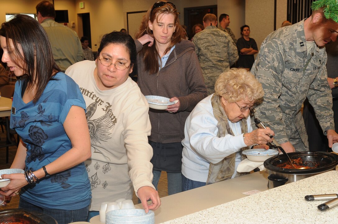 BUCKLEY AIR FORCE BASE, Colo.-- Members of Team Buckley celebrate the eighth annual Chili Cook-off at the base chapel, Jan. 5, 2011. Each person got to sample various types of chili from red and green, to mild and scorching hot. (U.S. Air Force photo by Airman Manisha Vasquez) 