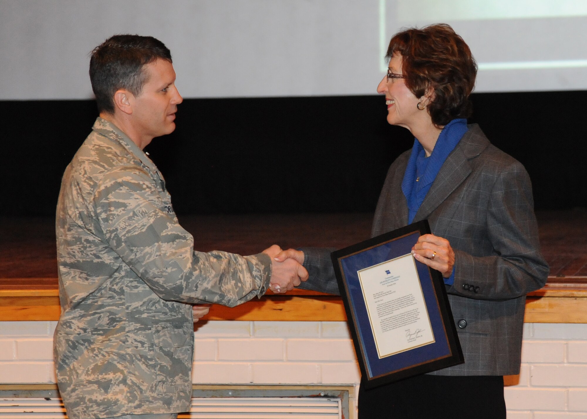 Col. Jamie Crowhurst, 22nd Air Refueling Wing commander, recognizes Mary Eary, 22nd Mission Support Group secretary, during a commander’s call held in the base theater Jan. 5, 2011, McConnell Air Force Base, Kan.  Mrs. Eary was recognized for her 53 years of dedicated service to McConnell.  (U.S. Air Force photo/Airman 1st Class Katrina M. Brisbin)