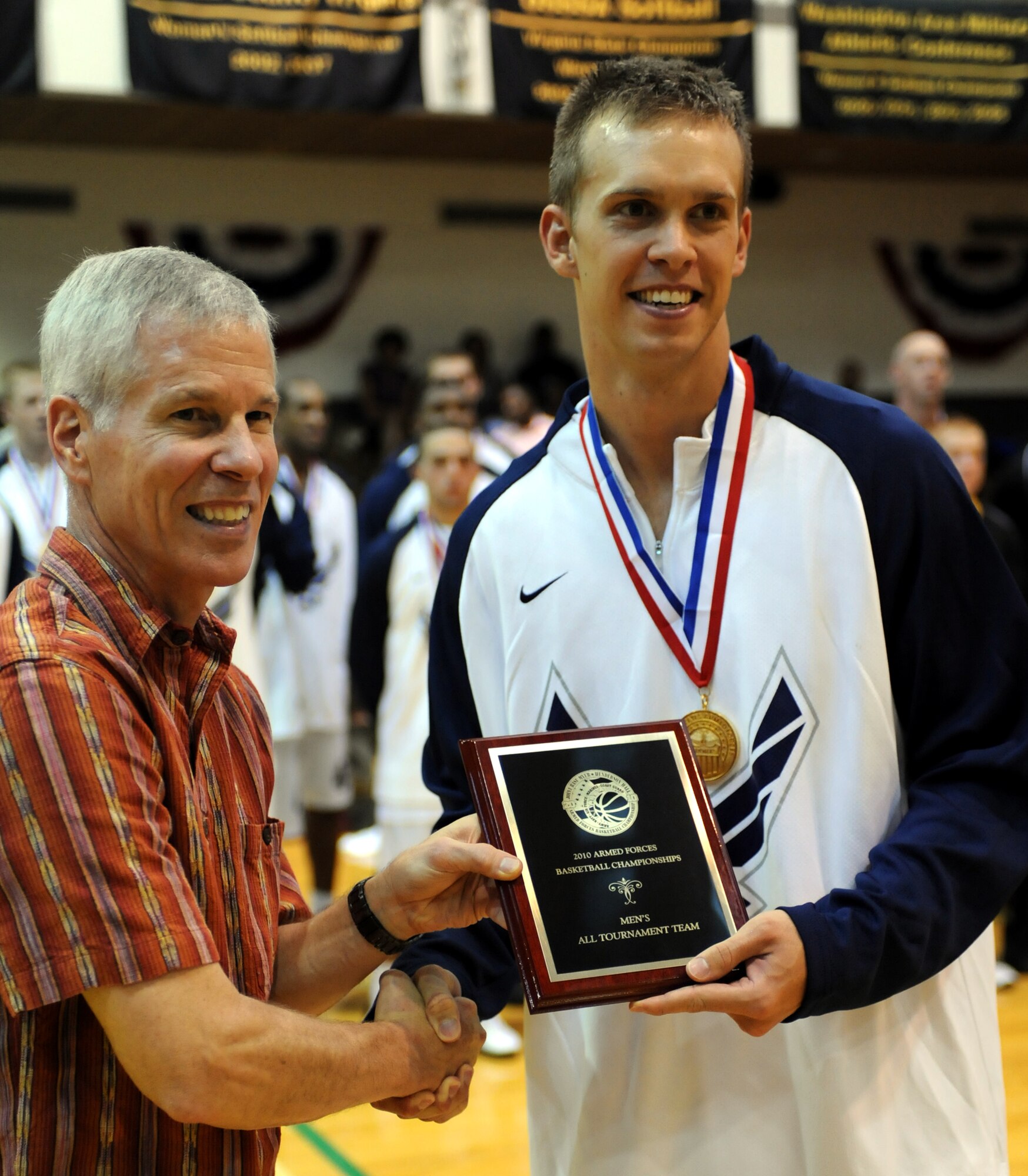 WASHINGTON - 2nd Lt. Matthew Holland receives a plaque from Gen. William L. Shelton, the Air Force Space Command commander, at an All Air Force tournament here in 2010. (U.S. Army photo/Tim Hipps)