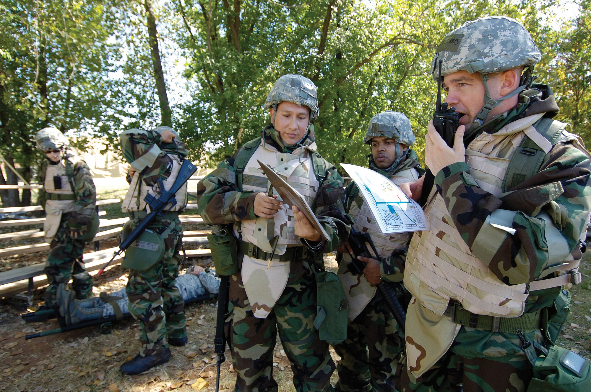During Tinker’s first exercise of the new fiscal year, WW-1101 held Oct. 18-22 brought 10 organizations from the 72nd Air Base Wing and the Oklahoma City Air Logistics Center into combat survival training scenarios. Capt. E.J. Morris calls in during a post-attack reconnaissance sweep with a 72nd Medical Group team including Tech. Sgt. Elizandro Rucoba and Staff Sgt. George Rico Orr, back. Other medical group team members prepare to take a “victim” for help. “These exercises reinforce ATSO (Ability to Survive and Operate) skills and maintain the level of competence and expertise we worked hard to reach in ’09,” said exercise controller Paul Logan. (Air Force photo by Margo Wright)

