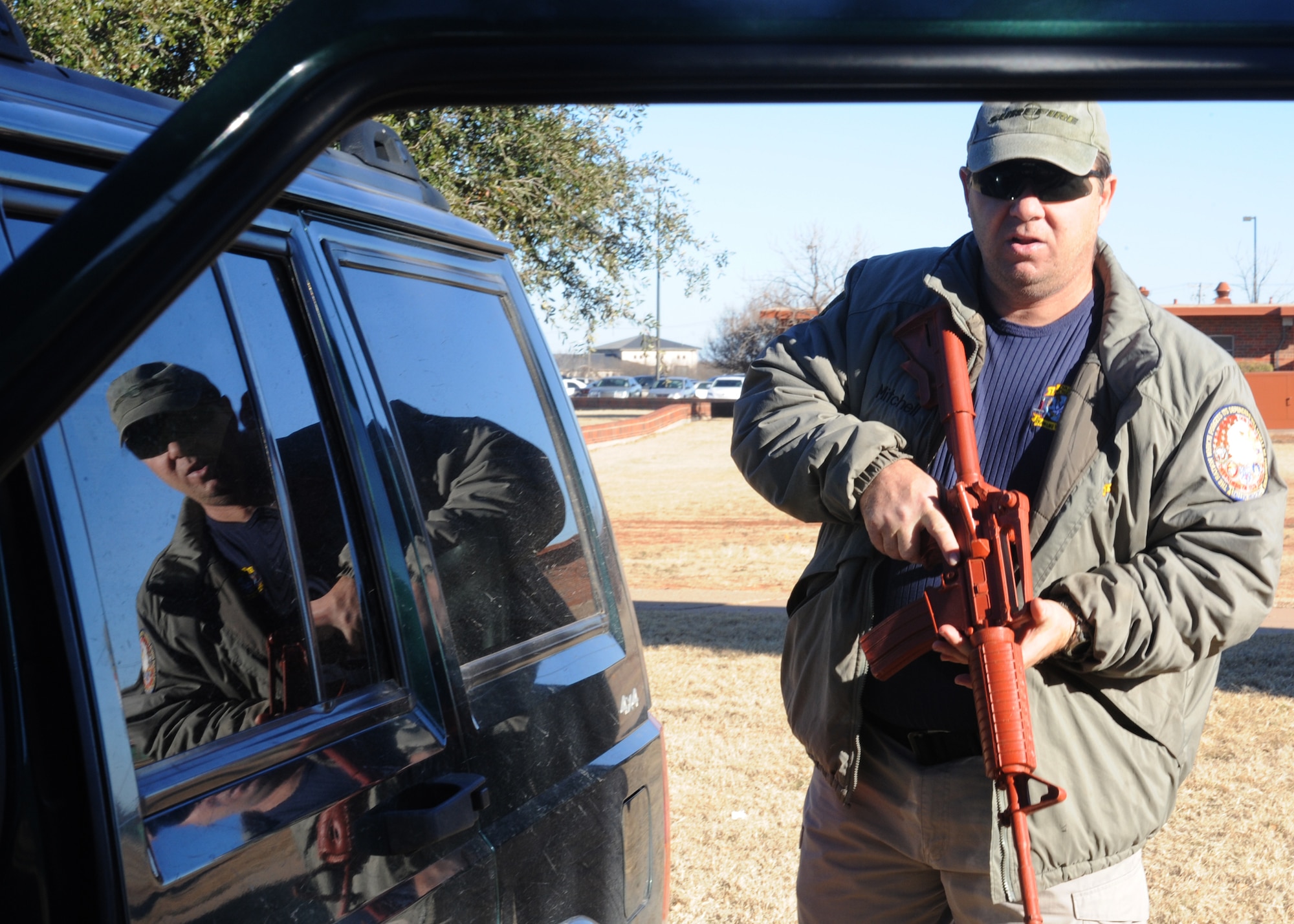 DYESS AIR FORCE BASE, Texas – Glenn Mitchell, 7th Security Forces Squadron trainer, clears a vehicle Jan. 5 during a security forces augmentee course held at the 7 SFS training building here. Members of the 317 AG are trained to be 7 SFS augmentees to provide additional installation security. (U.S. Air Force photo/Senior Airman Jenifer H. Calhoun)