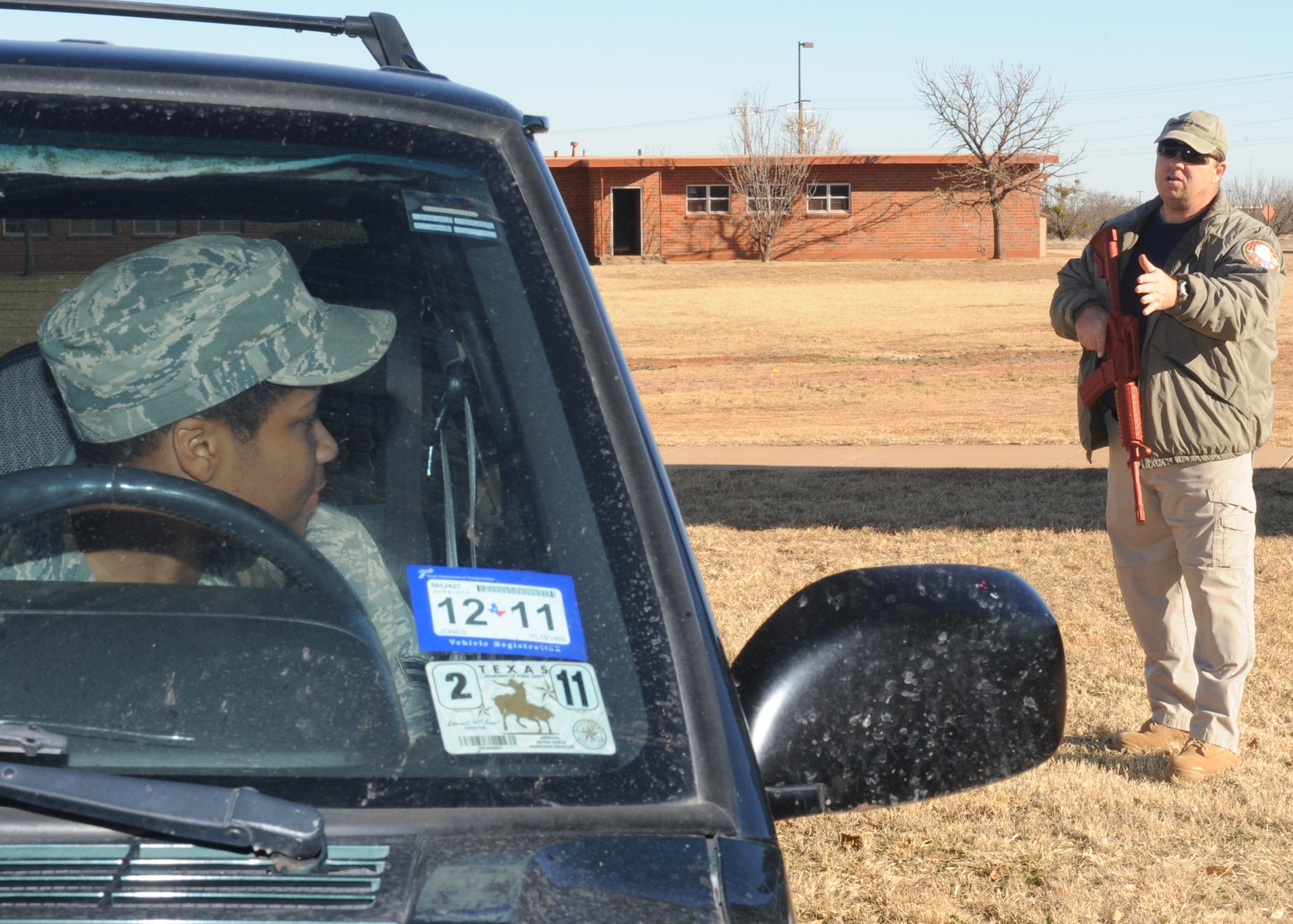 DYESS AIR FORCE BASE, Texas – Glenn Mitchell, 7th Security Forces Squadron trainer, instructs Airman 1st Class Christianjoy White, 317th Maintenance Operations Squadron, to turn off the vehicle while teaching vehicle challenge procedures Jan. 5 during a security forces augmentee course held at the 7 SFS training building here. Members of the 317 AG are trained to be 7 SFS augmentees to provide additional installation security. (U.S. Air Force photo/Senior Airman Jenifer H. Calhoun)