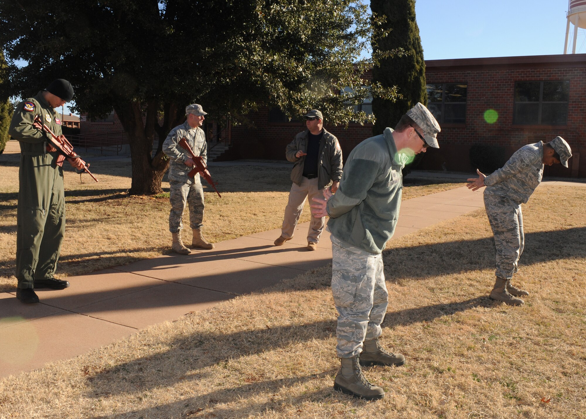 DYESS AIR FORCE BASE, Texas – Glenn Mitchell, 7th Security Forces Squadron trainer, teaches members of the 317th Airlift Group challenge procedures Jan. 5 during a security forces augmentee course held at the 7 SFS training building here. Members of the 317 AG are trained to be 7 SFS augmentees to provide additional installation security. (U.S. Air Force photo/Senior Airman Jenifer H. Calhoun)