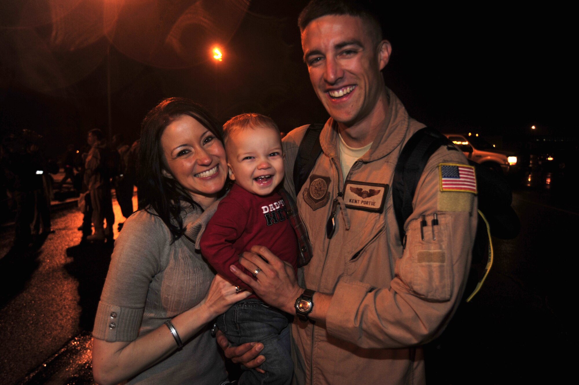 Capt. Kent Portue, right, 4th Airlift Squadron pilot, greets his wife, Andrea, and son, Kent, after returning home from a 120-day deployment Jan. 6 at McChord Field, Joint Base Lewis-McChord, Wash. (U.S. Air Force photo/ Airman Leah Young)