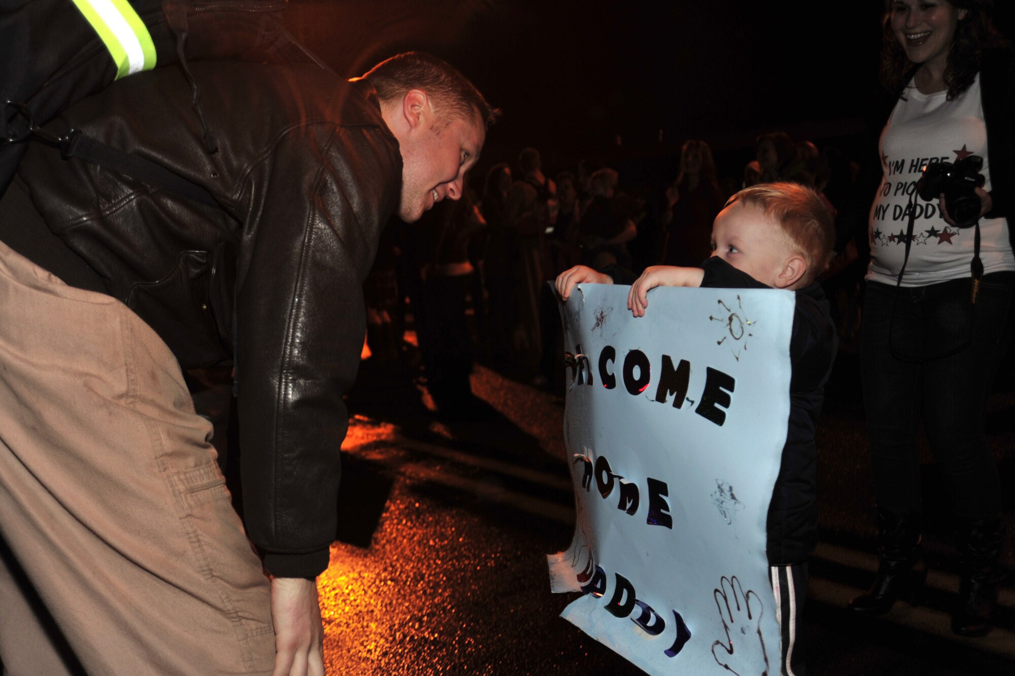 Capt. Christopher Costley, left, 4th Airlift Squadron pilot, is greeted by his son, Drew, 3, and wife, Tiffany, after returning from a deployment Jan. 6 at McChord Field, Joint Base Lewis-McChord, Wash. (U.S. Air Force photo/ Airman Leah Young)