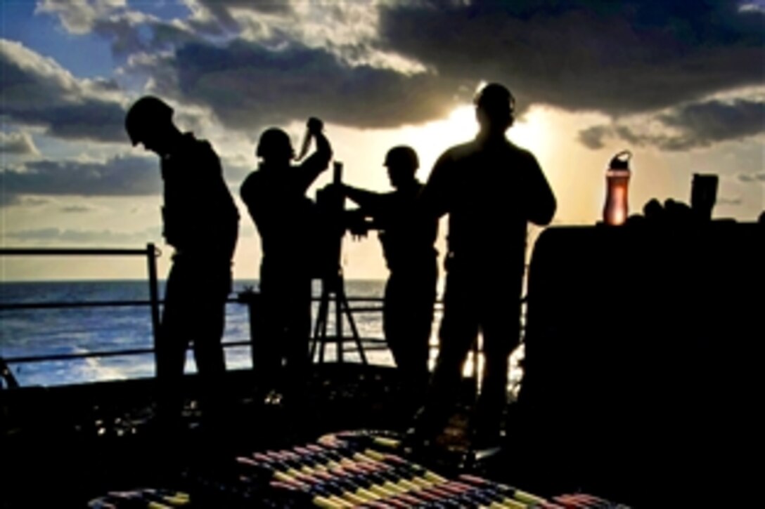 U.S. Navy sailors prepare a .50-caliber machine gun mount for a fire exercise on the fantail of the aircraft carrier USS Carl Vinson in the Pacific Ocean, Jan. 6, 2011. The Carl Vinson and Carrier Air Wing 17 are deployed to the U.S. 7th Fleet area of responsibility.