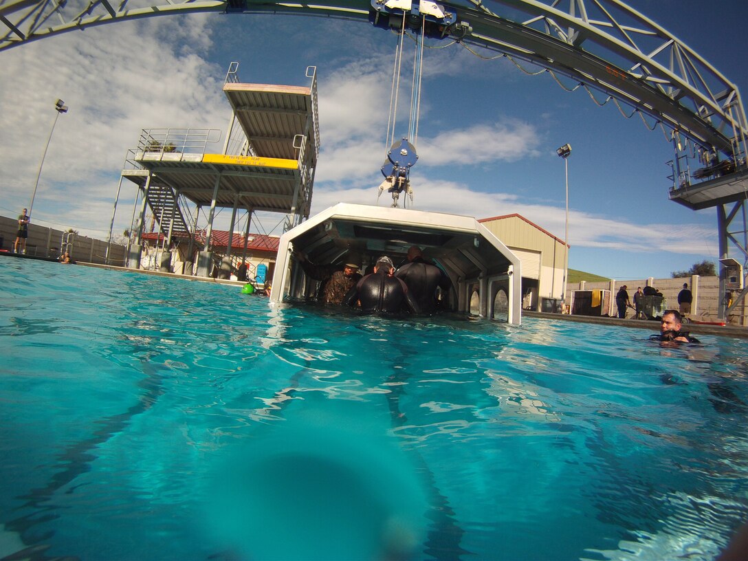 The Modular Amphibious Egress Trainer course teaches Marines and sailors how to escape from a submerging helicopter Jan. 7. As the helo dunker is submerged under water, Marines with the 11th Marine Expeditionary Unit and Combat Logistics Battalion 11 make their way out of the helicopter through emergency exits located throughout the simulated aircraft.