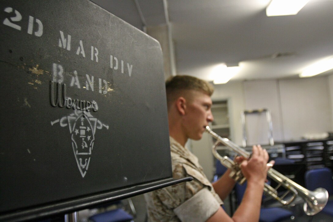 Lance Cpl. Brandon W. Moore, a trumpet player for the 2nd Marine Division Band, warms up with his instrument aboard Marine Corps Base Camp Lejeune, N.C. Moore played the trumpet throughout high school. (Official U.S. Marine Corps photo by Lance Cpl. Walter D. Marino II)