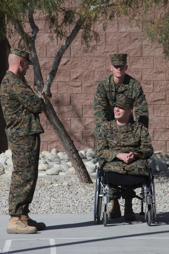 Corporal Jonathan Dowdell talks with his former company commander Capt. James Lindler with Company K, 3rd Battalion, 7th Marine Regiment, just before being awarded the Navy Marine Corps Achievement  Medal with Combat distinguishing Device for his bold actions and courageous sacrifice in support of Operation Enduring Freedom while he was deployed with the unit in June.