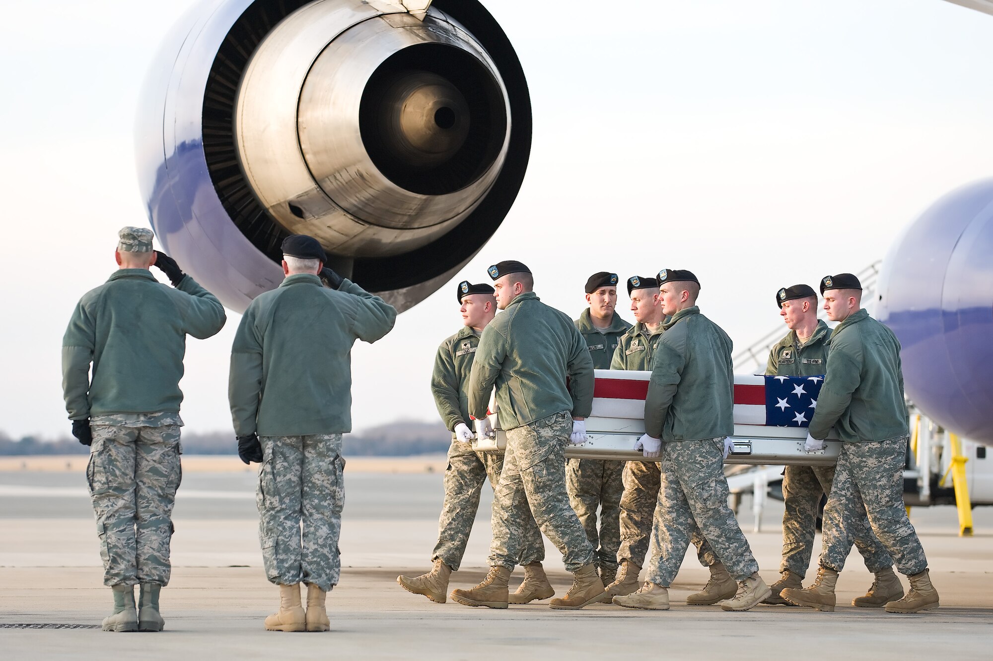 A U.S. Army carry team transfers the remains of Army Spc. Christian J. Romig, of Kenner, La., at Dover Air Force Base, Del., Jan. 7, 2011. He was assigned to 1st Squadron, 61st Cavalry, 4th Brigade Combat Team, 101st Airborne Division (Air Assault), Fort Campbell, Ky. (U.S. Air Force photo/Roland Balik)