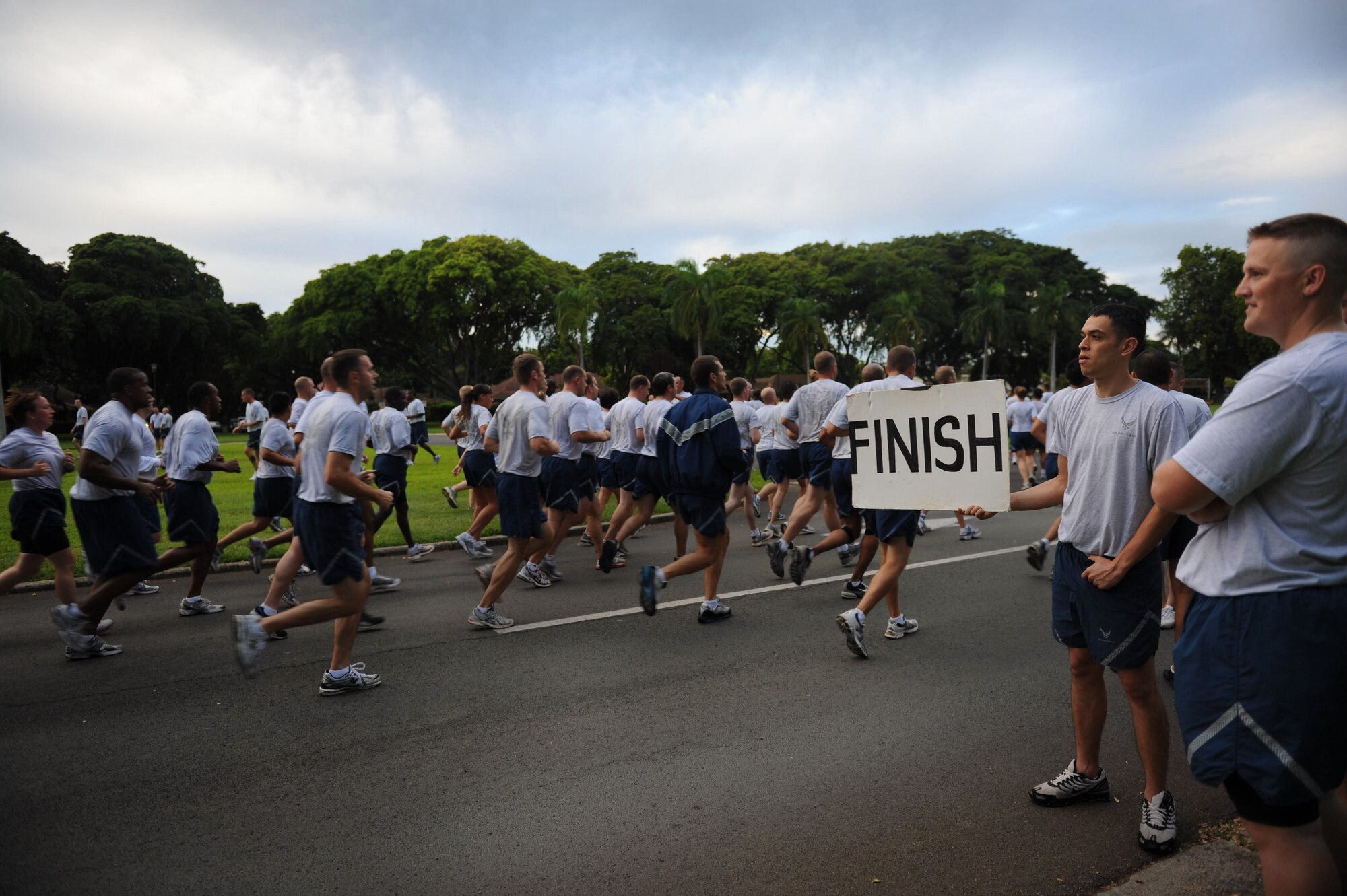 Airmen finish the Warrior Run Jan. 7 outside the 15th Wing Headquarters Building at Joint Base Pearl Harbor-Hickam, Hawaii.  Nearly 1,100 participants ran the approximately two-mile course. (U.S. Air Force photo/Airman 1st Class Lauren Main)
