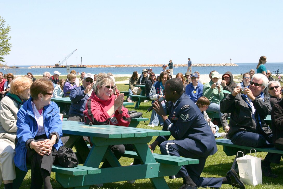 Technical Sergeant Albert Williams serenades an audience member at a concert in Mackinac Island, Michigan. Technical Sergeant Williams is a member of the USAF Band of Mid-America which is based out of Scott Air Force Base, Illinois. 