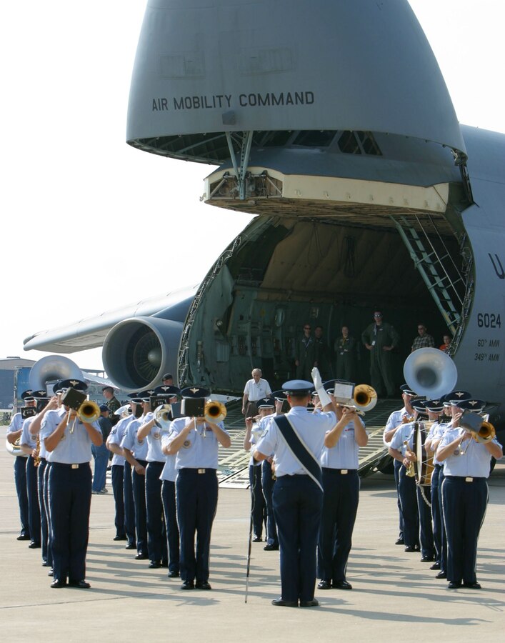 Members of the USAF Band of Mid-America’s Ceremonial Band play marches and the music of America, as onlookers stand and listen inside the nose of a C-5. The USAF Band of Mid-America is based out of Scott Air Force Base in Illinois.