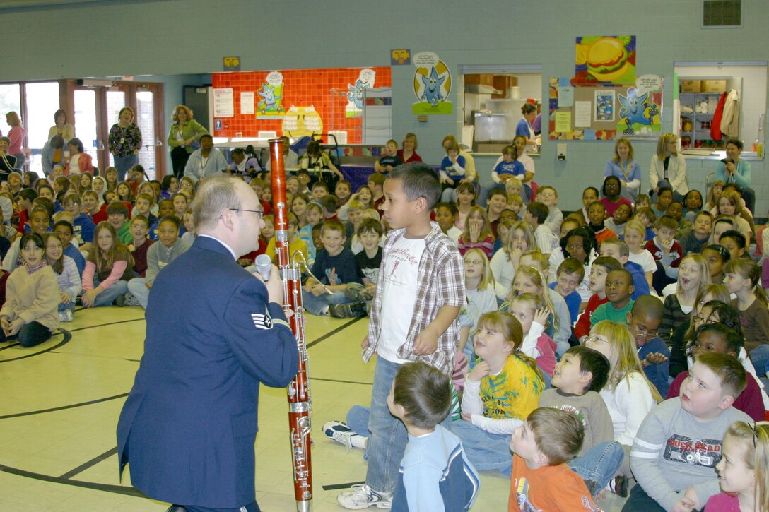 Technical Sergeant Robert Jordan teaches a student about the functionality of his instrument, the bassoon. TSgt Jordan is a member of Midwest Winds, a woodwind quintet, assigned to the USAF Band of Mid-America based out of Scott Air Force Base, Illinois.