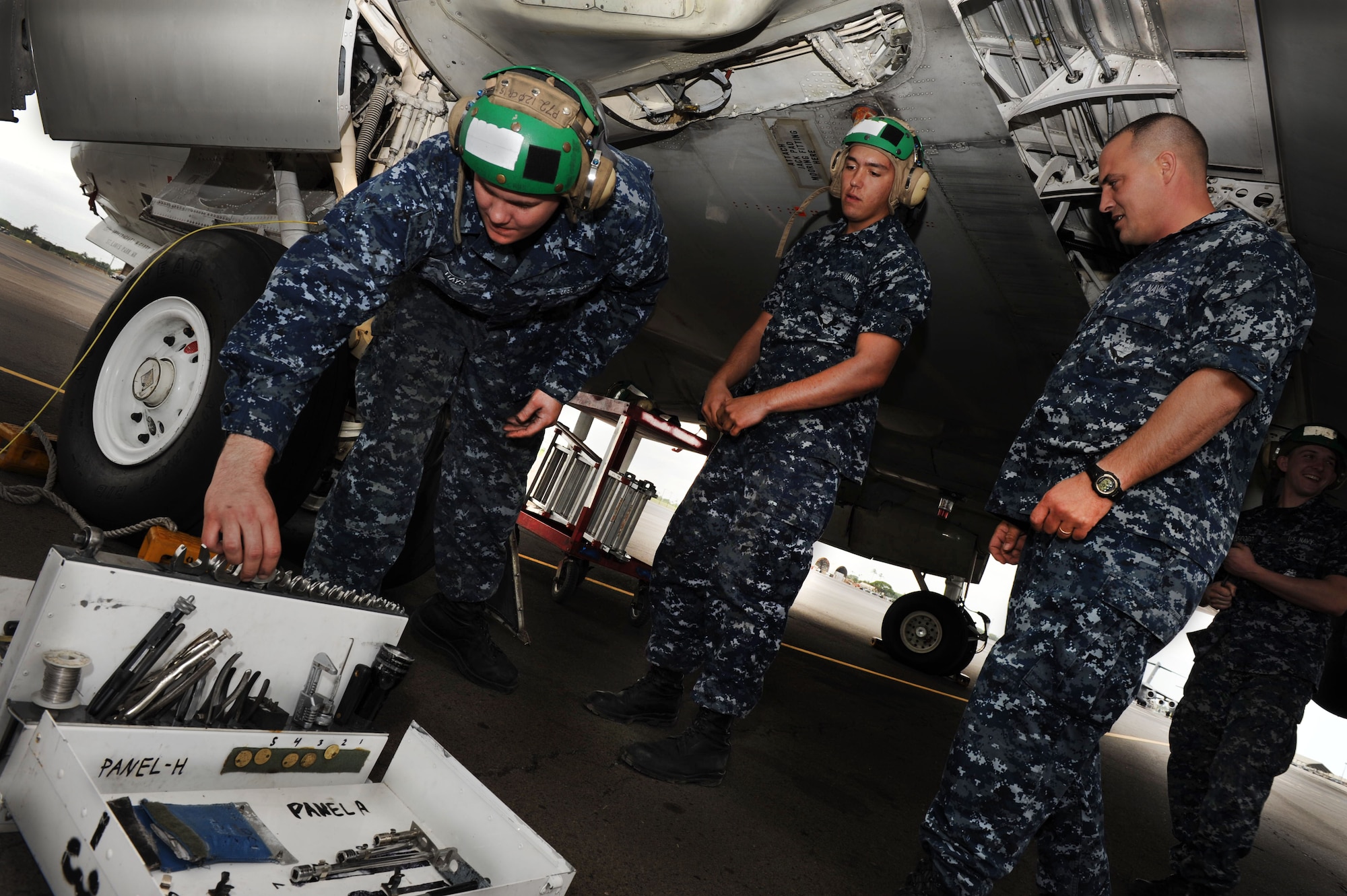 Sailors from Marine Corps Base Hawaii make repairs to a U.S. Navy P-3 Orion aircraft on the 15th Wing flightline Jan. 6. The aircraft are temporarily being housed by the 15th Wing due to runway construction at MCBH. The P-3s were initially released to the Navy in 1962 and are used to detect enemy submarines and aircraft. They are also used to view battlespace in order to relay information instantaneously to ground troops. (U.S. Air Force Photo/Airman 1st Class Lauren Main)