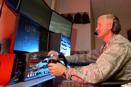 Col. William H. Mott V, 37th Training Wing commander, tries one of the new flight simulators at the Inter-American Air Forces Academy Dec. 16. The new simulators create a more realistic environment for students and instructors. (U.S. Air Force photo/Robbin Cresswell)